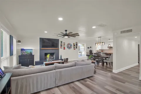 a living room with fireplace furniture and a wooden floor