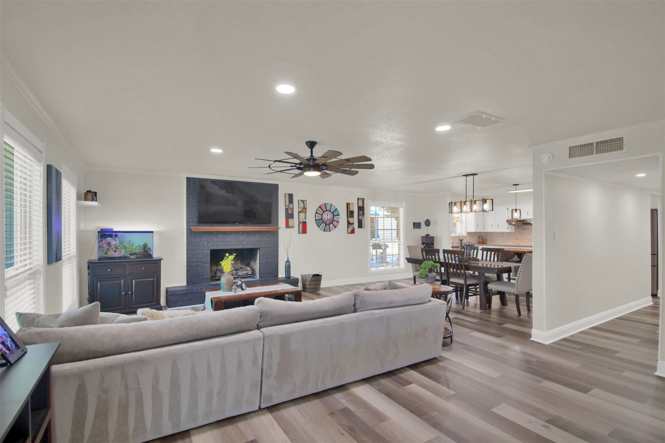 550 C.Bud Stockton Loop Jarrell, TX 76537 - Photo 4 of 37 Living area featuring recessed lighting, light wood-style floors, a brick fireplace, and ceiling fan