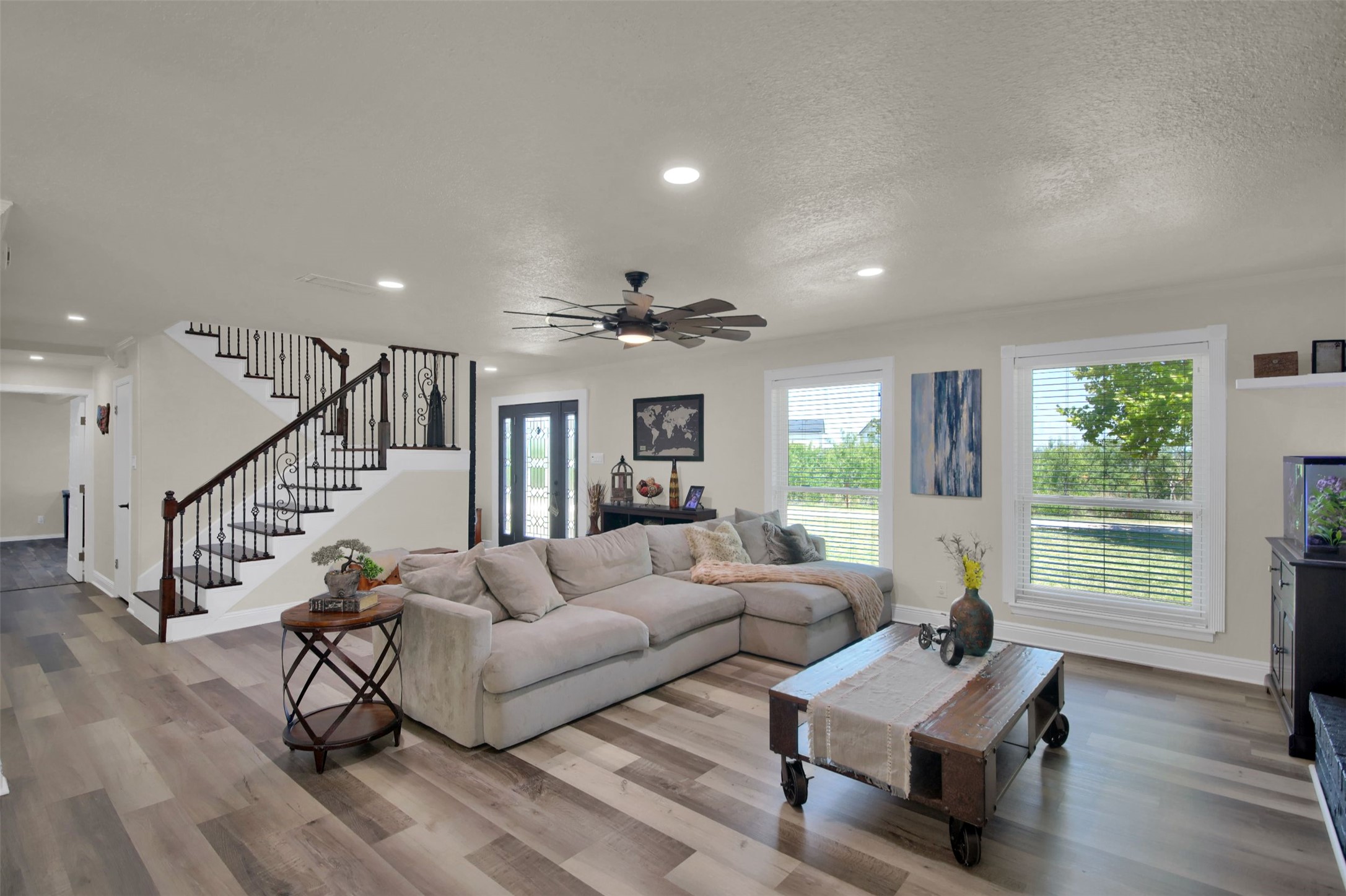 550 C.Bud Stockton Loop Jarrell, TX 76537 - Photo 6 of 37 Living area featuring light wood-style floors, stairs, recessed lighting, ceiling fan, and a textured ceiling