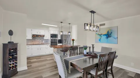 a view of a dining room with furniture wooden floor and chandelier