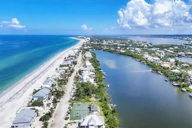 an aerial view of a city with lake view in back