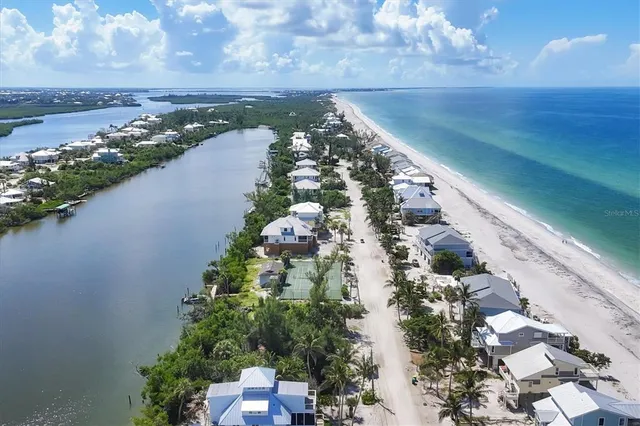 an aerial view of a houses with a yard