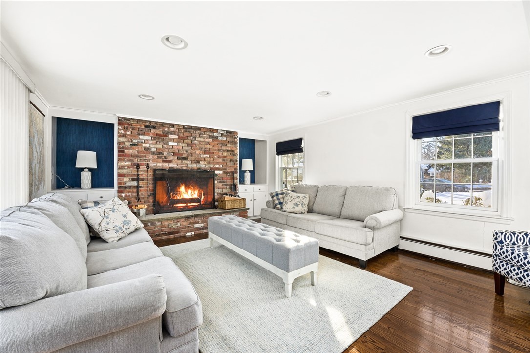 27 Lee Road Barrington, RI 02806 - Photo 10 of 22 spacious family room with freplace and more built in's and sliders to backyard