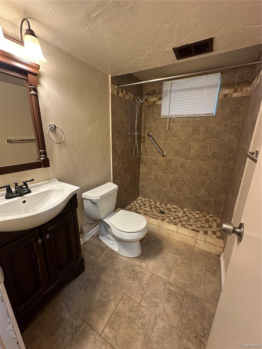 1836 East Mineral Avenue Centennial, CO 80122 - Photo 19 of 25 a bathroom with a sink toilet and shower
