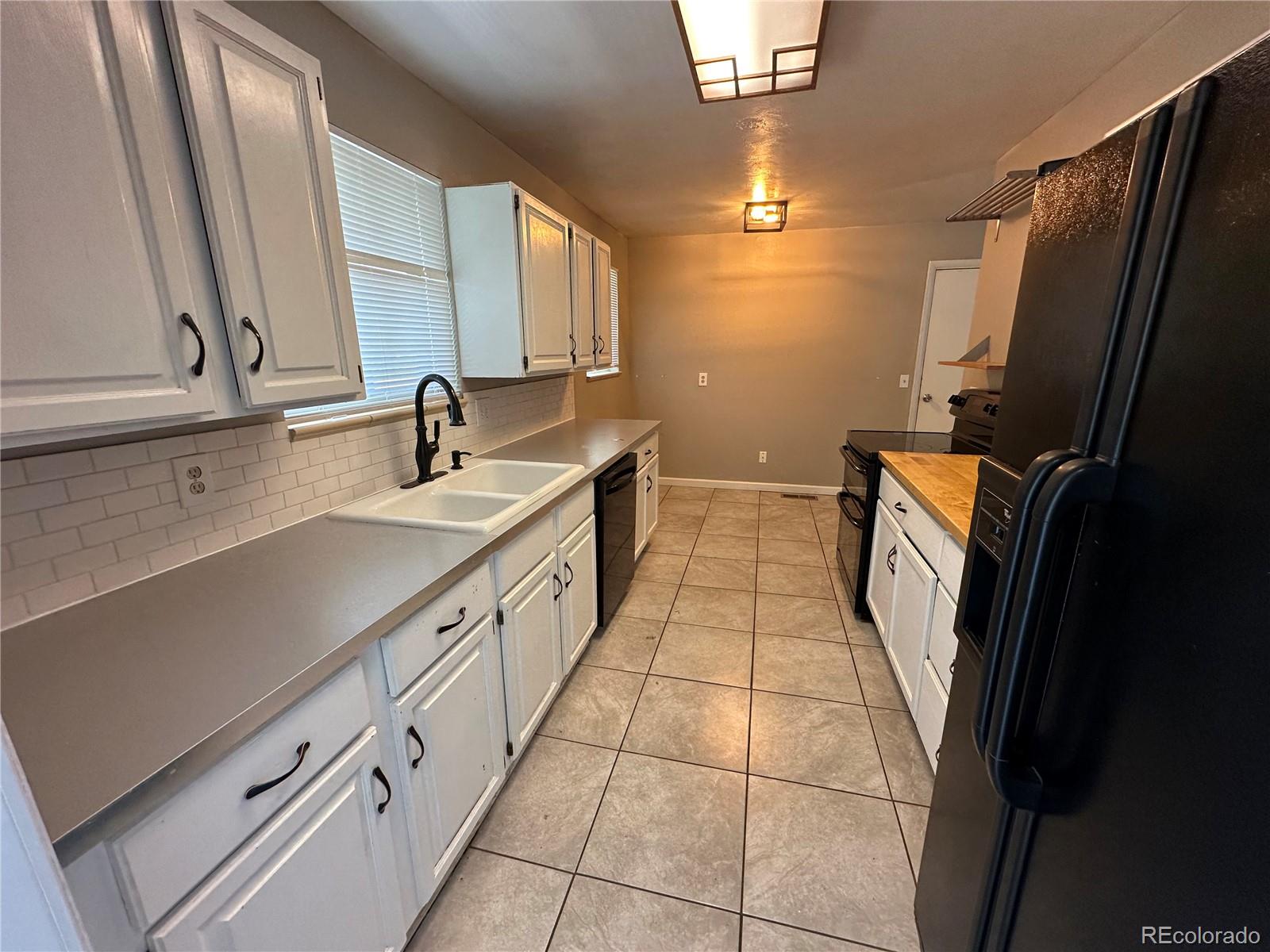 1836 East Mineral Avenue Centennial, CO 80122 - Photo 3 of 25 a bathroom with a double vanity sink a mirror and a bathtub