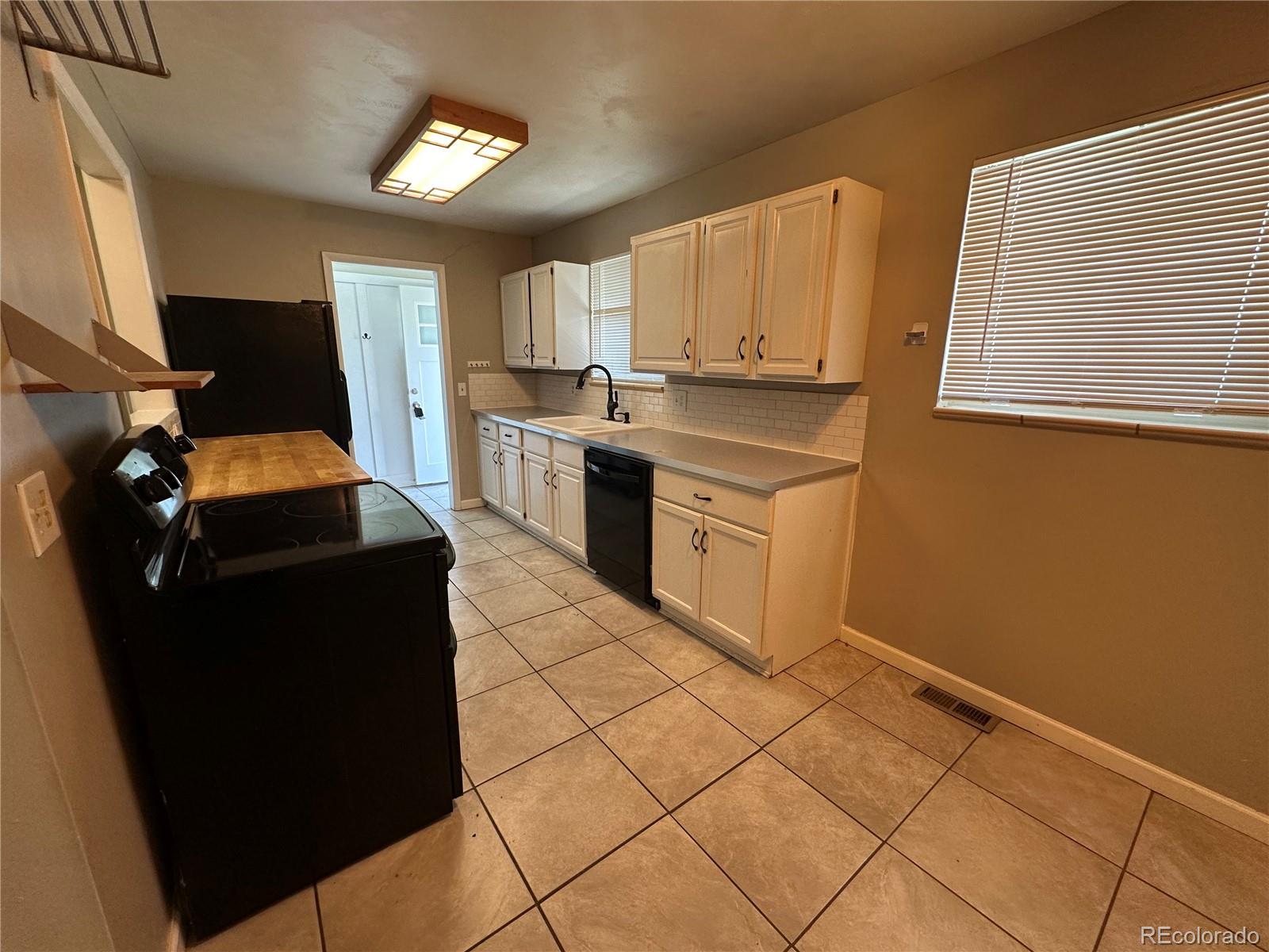 1836 East Mineral Avenue Centennial, CO 80122 - Photo 4 of 25 a kitchen with a sink cabinets and window