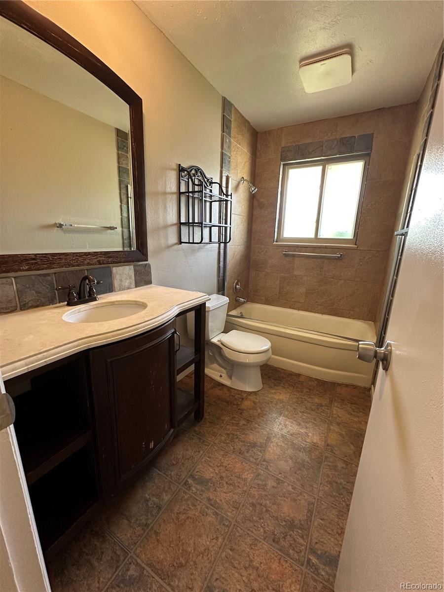 1836 East Mineral Avenue Centennial, CO 80122 - Photo 7 of 25 a bathroom with a double vanity sink toilet and mirror