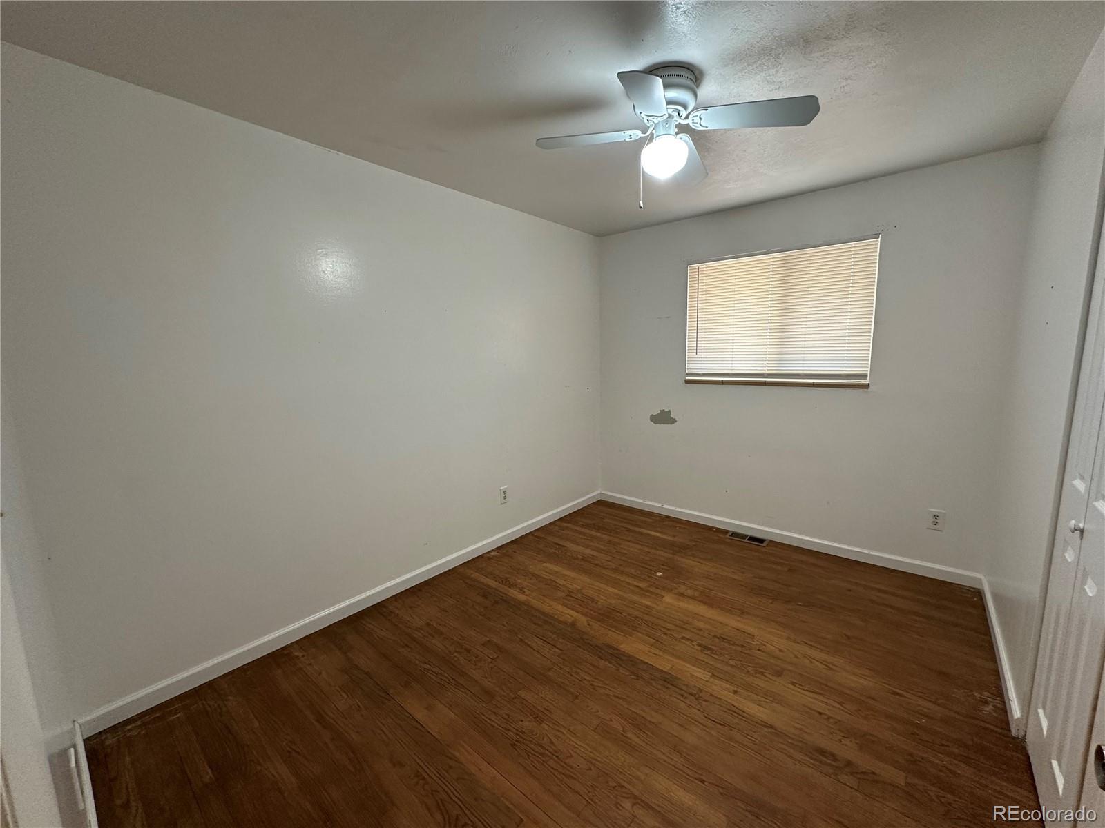 1836 East Mineral Avenue Centennial, CO 80122 - Photo 8 of 25 wooden floor in an empty room with a window