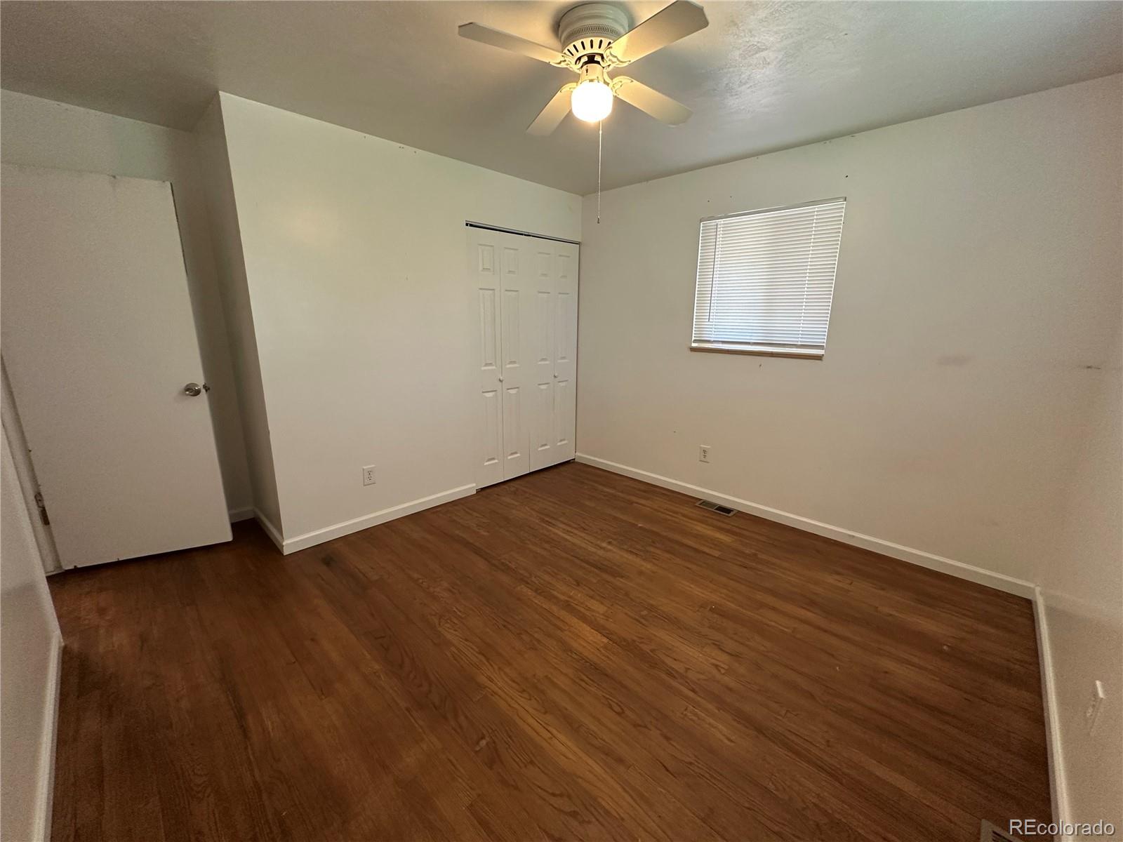 1836 East Mineral Avenue Centennial, CO 80122 - Photo 10 of 25 an empty room with wooden floor fan and windows