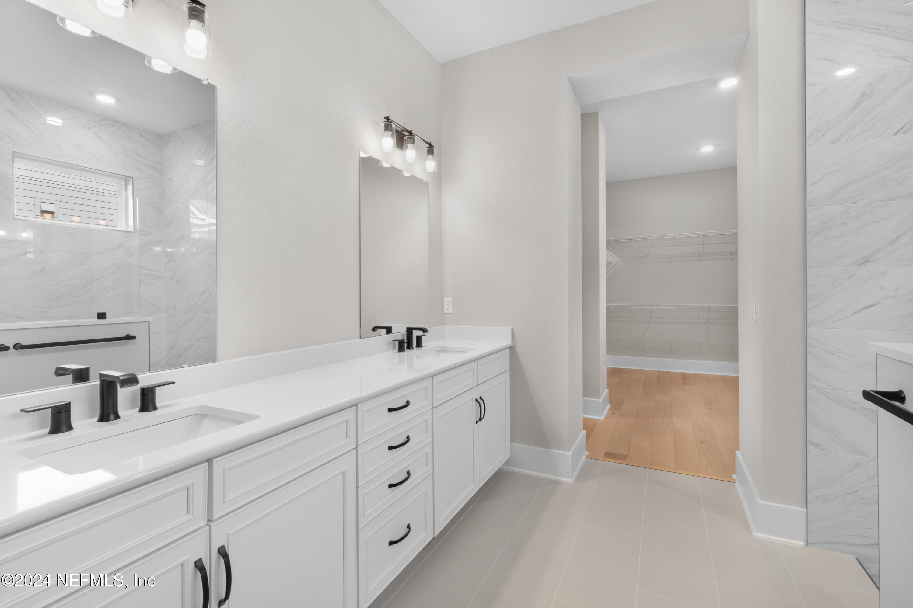 393 Canopy Forest Dr Street St. Augustine, FL 32092 - Photo 15 of 18 a bathroom with a double vanity sink a mirror and a shower
