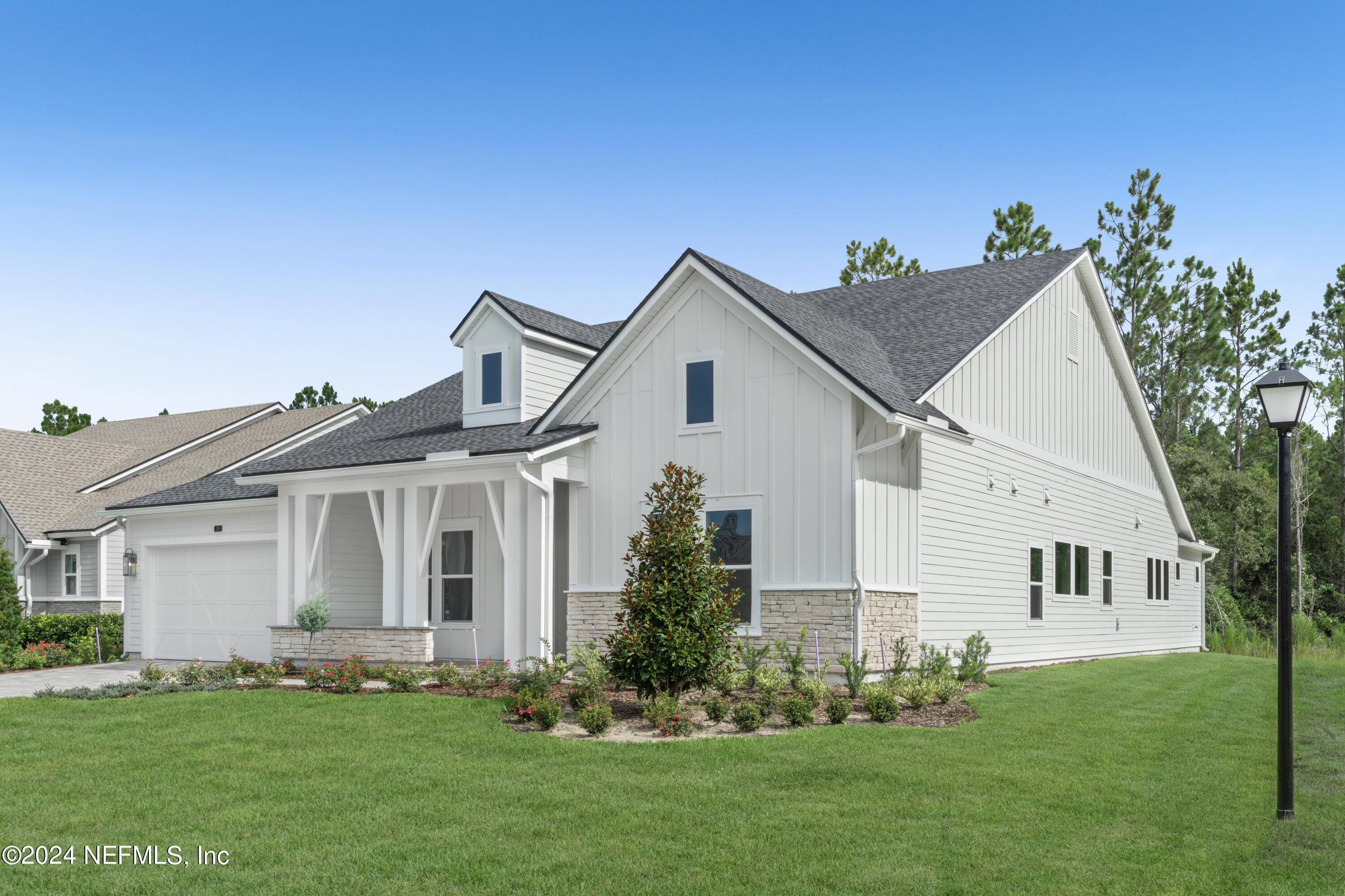 393 Canopy Forest Dr Street St. Augustine, FL 32092 - Photo 2 of 18 a front view of a house with a garden