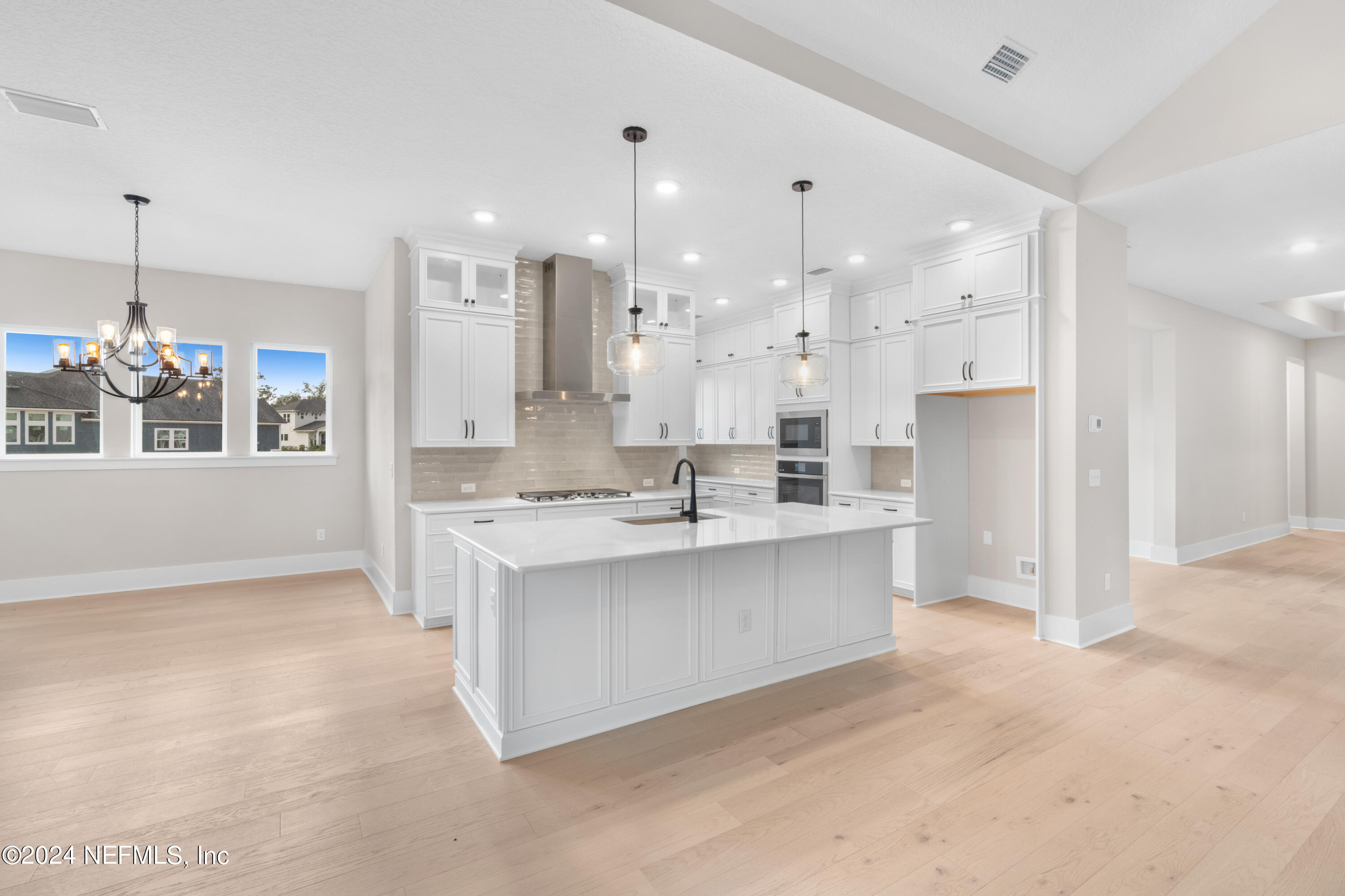 393 Canopy Forest Dr Street St. Augustine, FL 32092 - Photo 3 of 18 a large white kitchen with a large window and stainless steel appliances