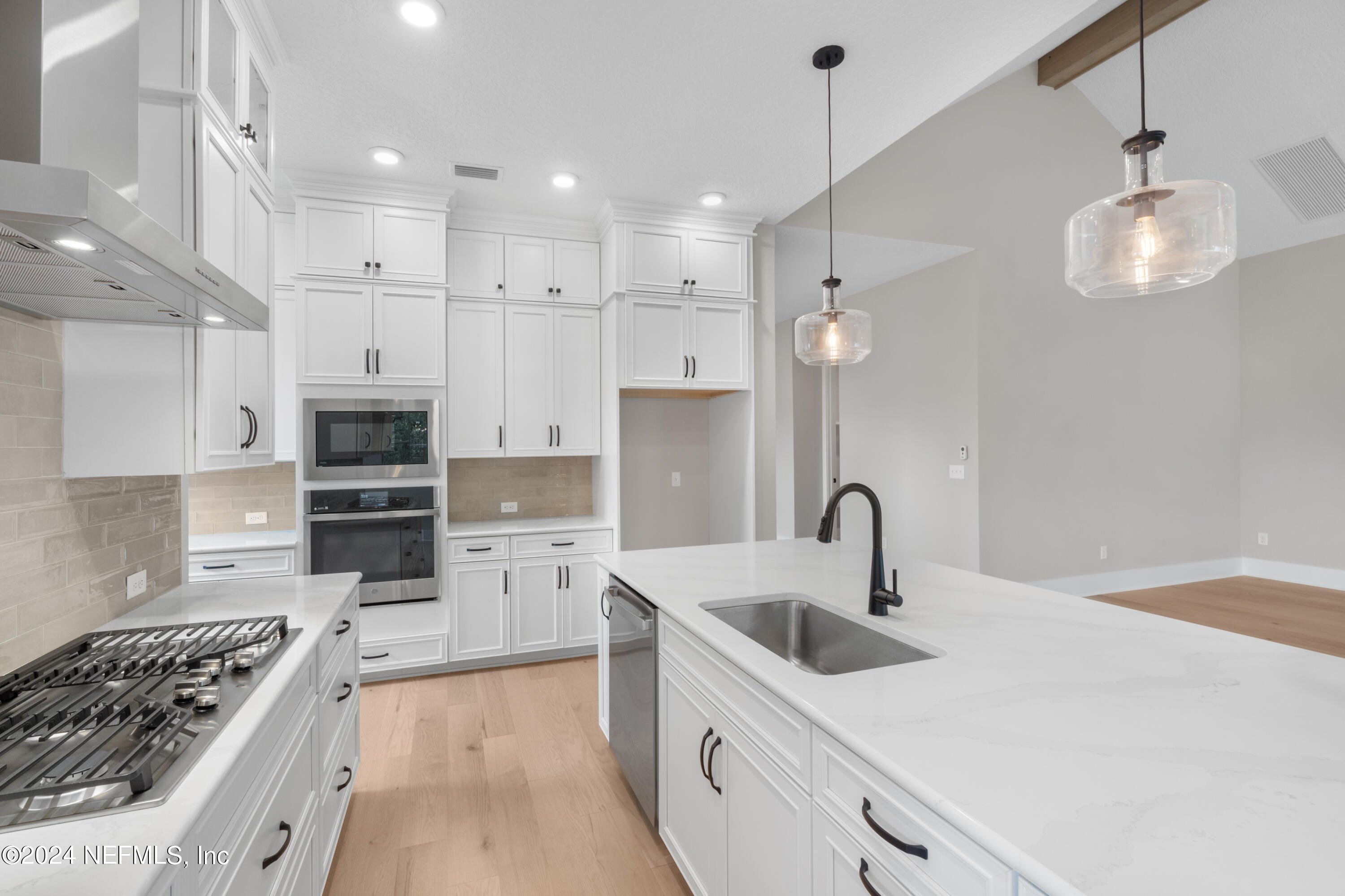 393 Canopy Forest Dr Street St. Augustine, FL 32092 - Photo 9 of 18 a kitchen with a sink stove and refrigerator