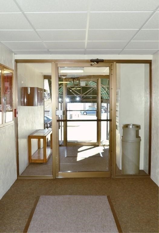 46 Cochituate Road, Unit 408 Framingham, MA 01701 - Photo 4 of 20 a lobby with furniture and floor to ceiling window