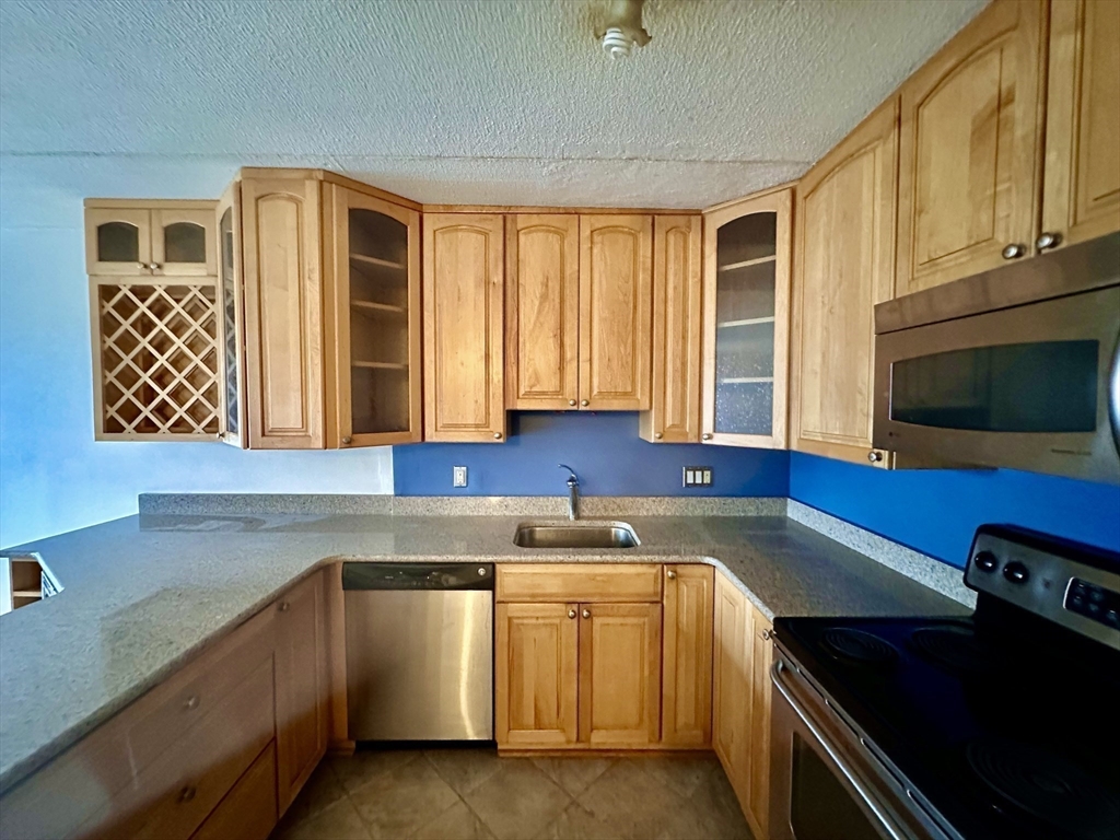 46 Cochituate Road, Unit 408 Framingham, MA 01701 - Photo 5 of 20 a kitchen with a sink cabinets and window