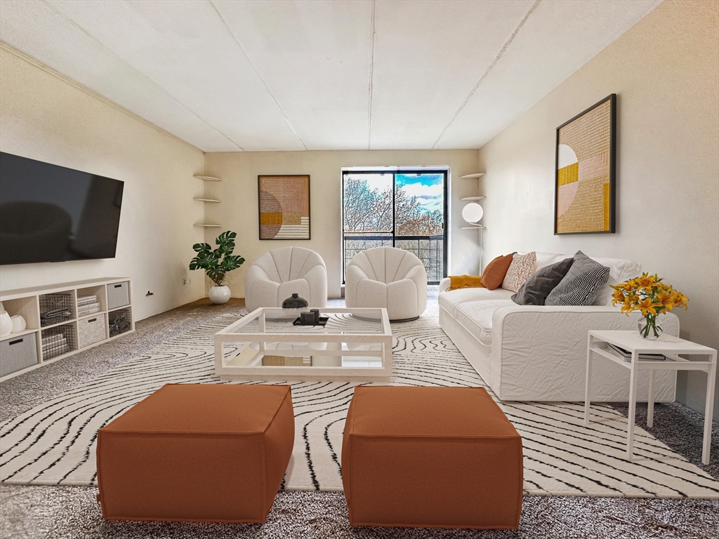 46 Cochituate Road, Unit 408 Framingham, MA 01701 - Photo 8 of 20 a living room with furniture and a flat screen tv