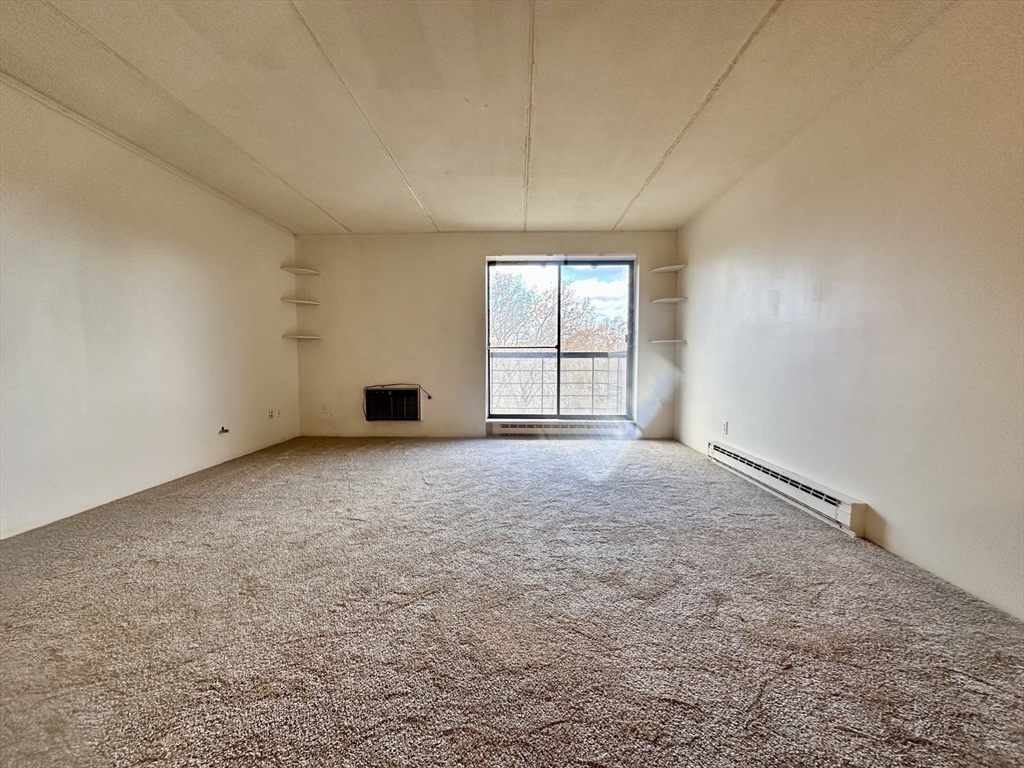 46 Cochituate Road, Unit 408 Framingham, MA 01701 - Photo 9 of 20 an empty room with windows and closet