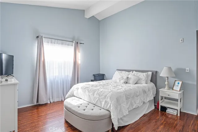 a bedroom with a bed and a chair