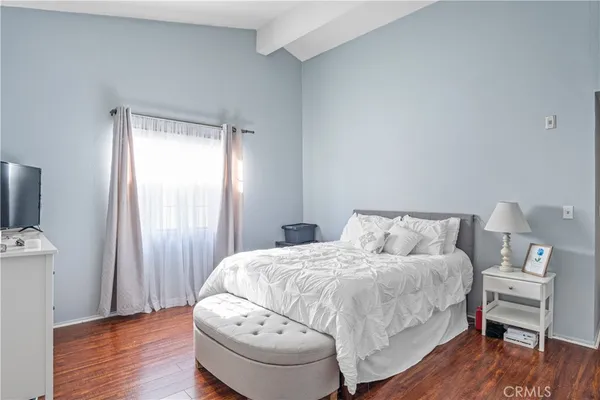 a bedroom with a bed and a chair