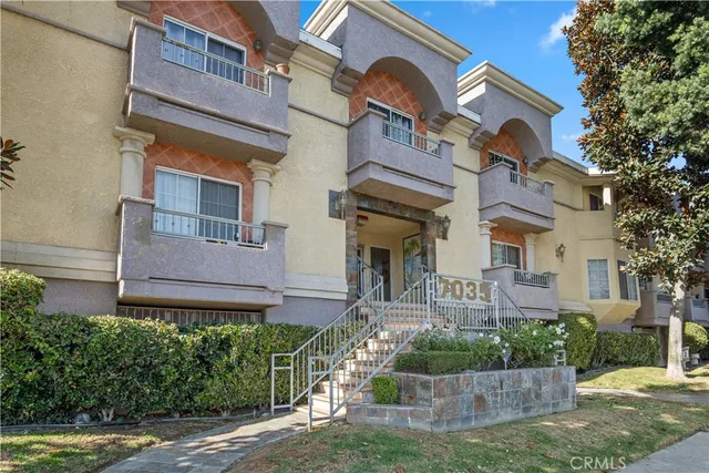 a front view of a house with plants