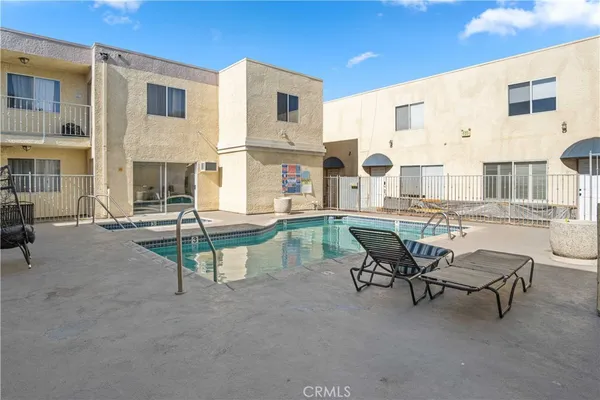 a swimming pool with outdoor seating