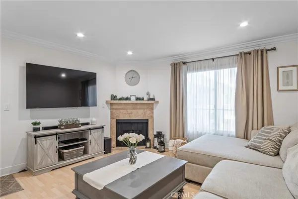 a living room with furniture a flat screen tv and a fireplace