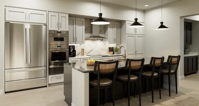 a kitchen with stainless steel appliances a refrigerator and microwave