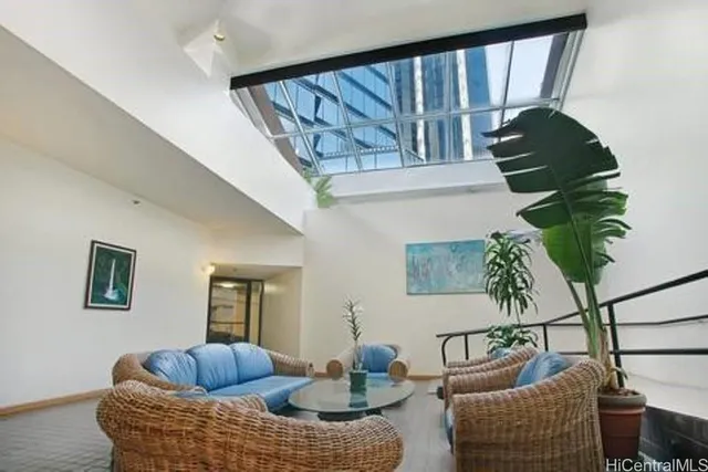 a view of a living room with furniture and a kitchen