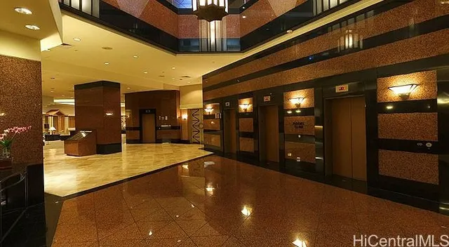 a lobby with a couch and a view of living room