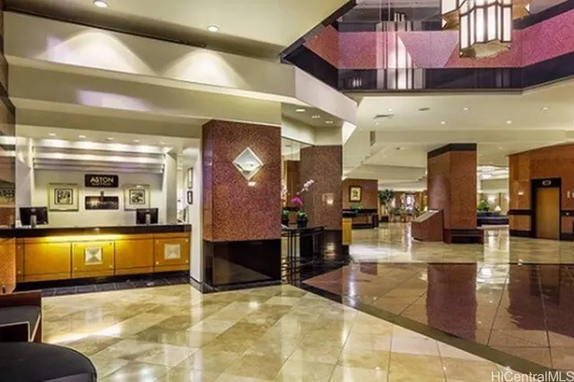 a roof deck with couches and potted plants