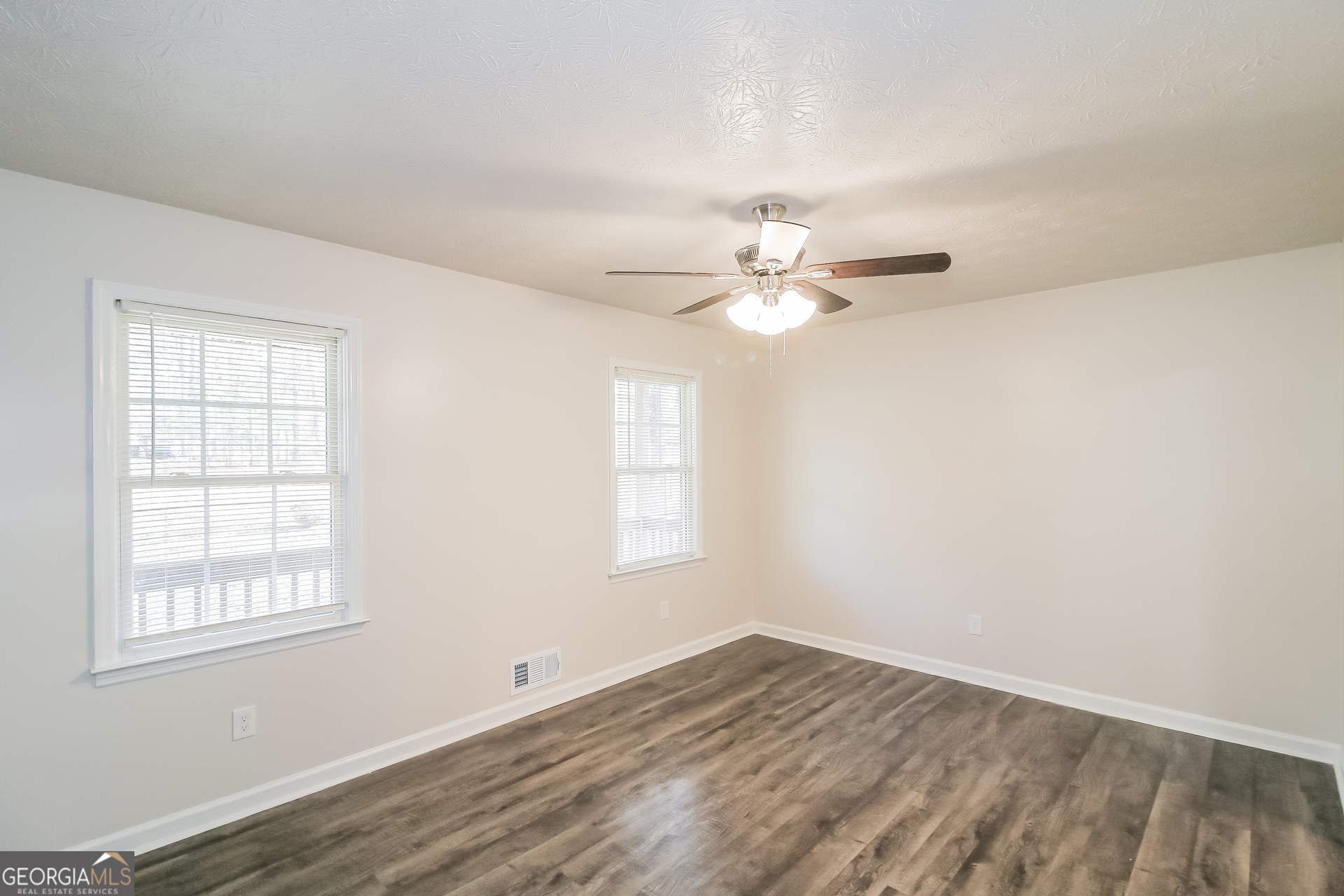 632 Cloudland Drive Stockbridge, GA 30281 - Photo 4 of 18 an empty room with wooden floor and windows