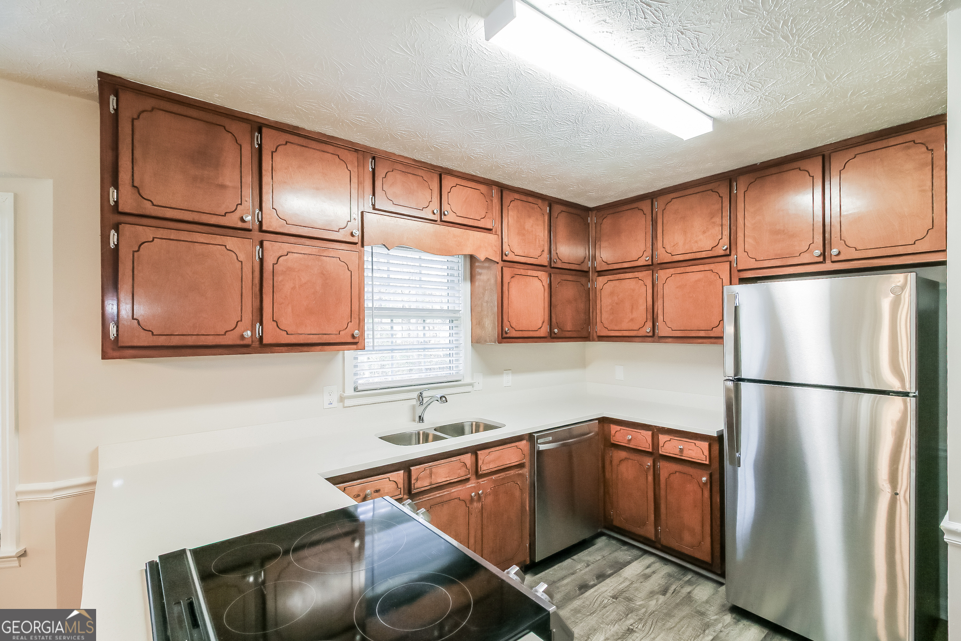 632 Cloudland Drive Stockbridge, GA 30281 - Photo 6 of 18 a kitchen with stainless steel appliances granite countertop a refrigerator a sink and a cabinets