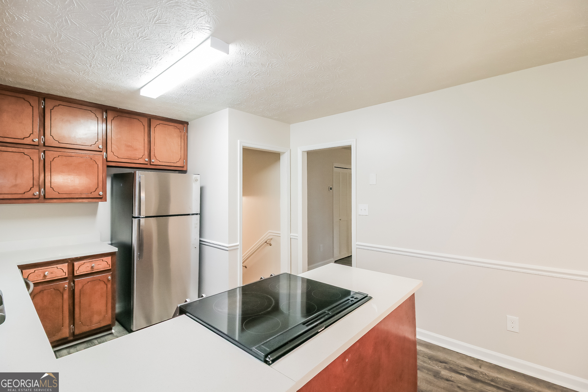 632 Cloudland Drive Stockbridge, GA 30281 - Photo 7 of 18 a kitchen with stainless steel appliances granite countertop a refrigerator a stove and a refrigerator with wooden floor