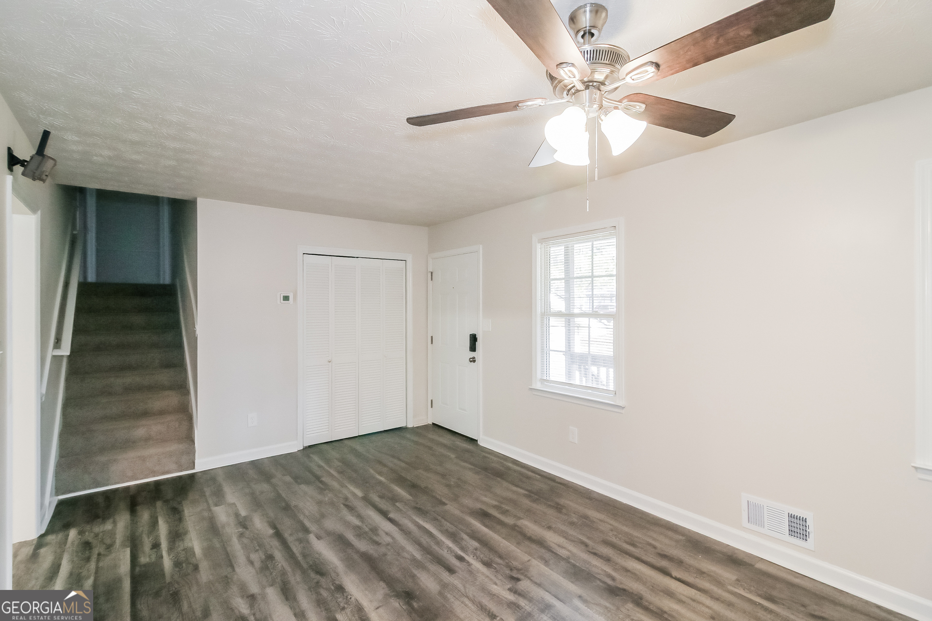 632 Cloudland Drive Stockbridge, GA 30281 - Photo 8 of 18 wooden floor in an empty room with a window