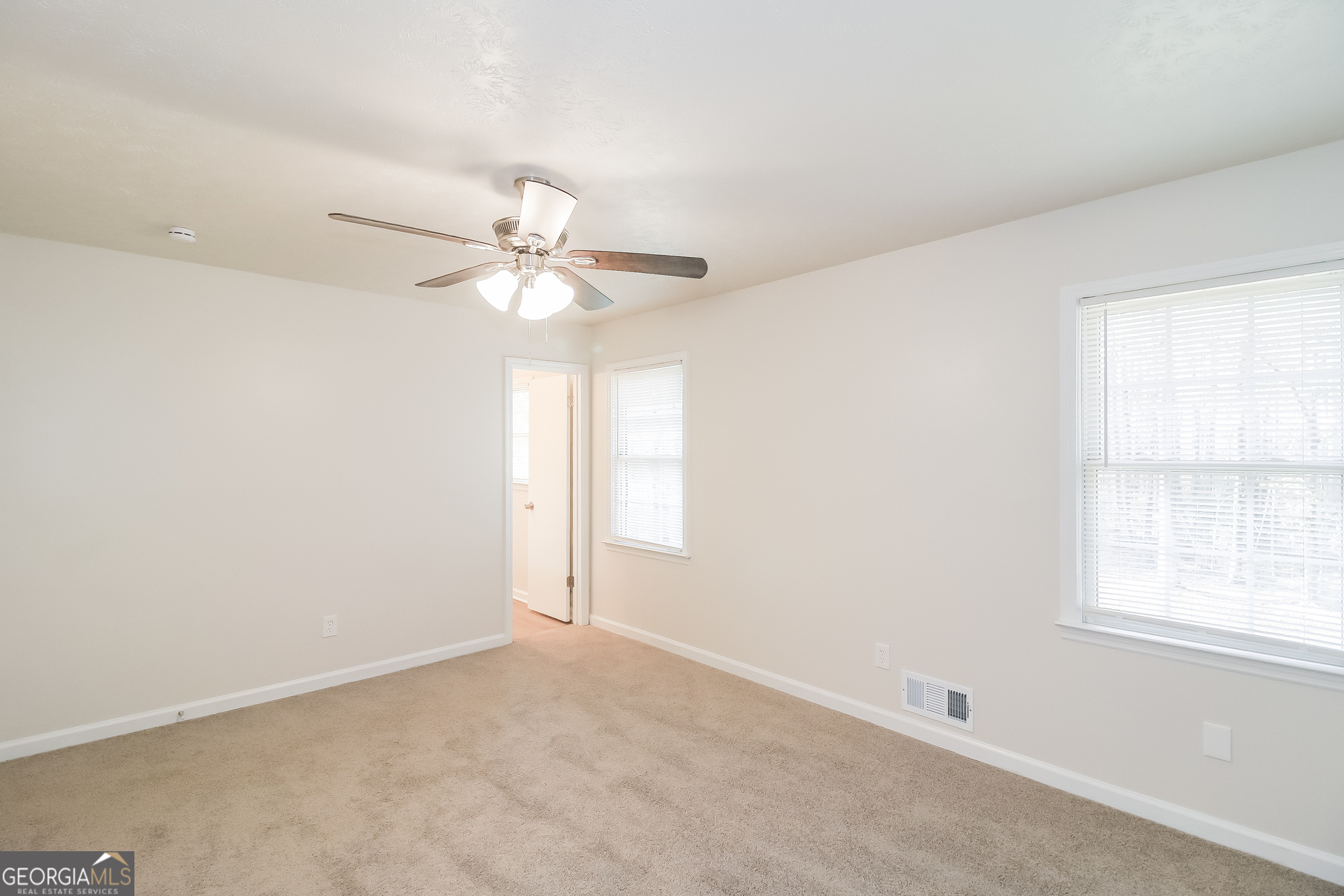 632 Cloudland Drive Stockbridge, GA 30281 - Photo 9 of 18 an empty room with a window and a fan