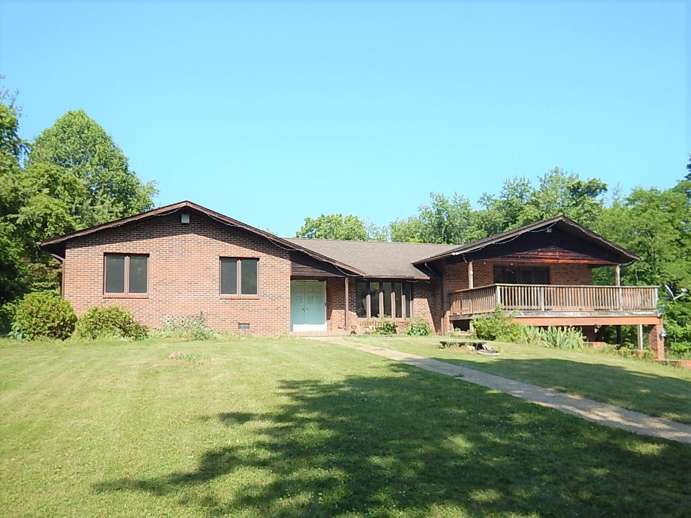 a front view of house with yard and green space