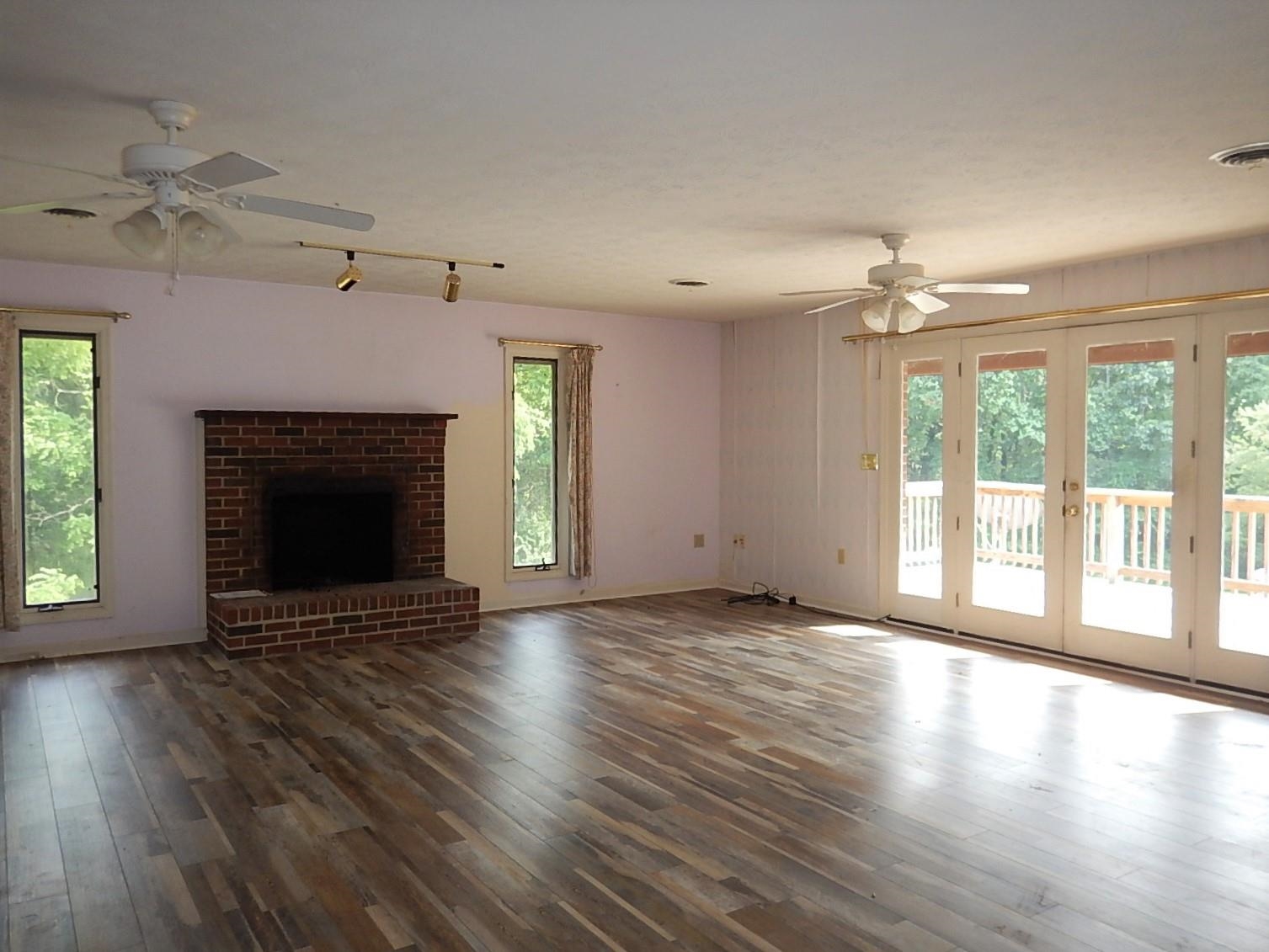 161 Smoky Row Road Staunton, VA 24401 - Photo 12 of 25 a view of an empty room with wooden floor fireplace and a window