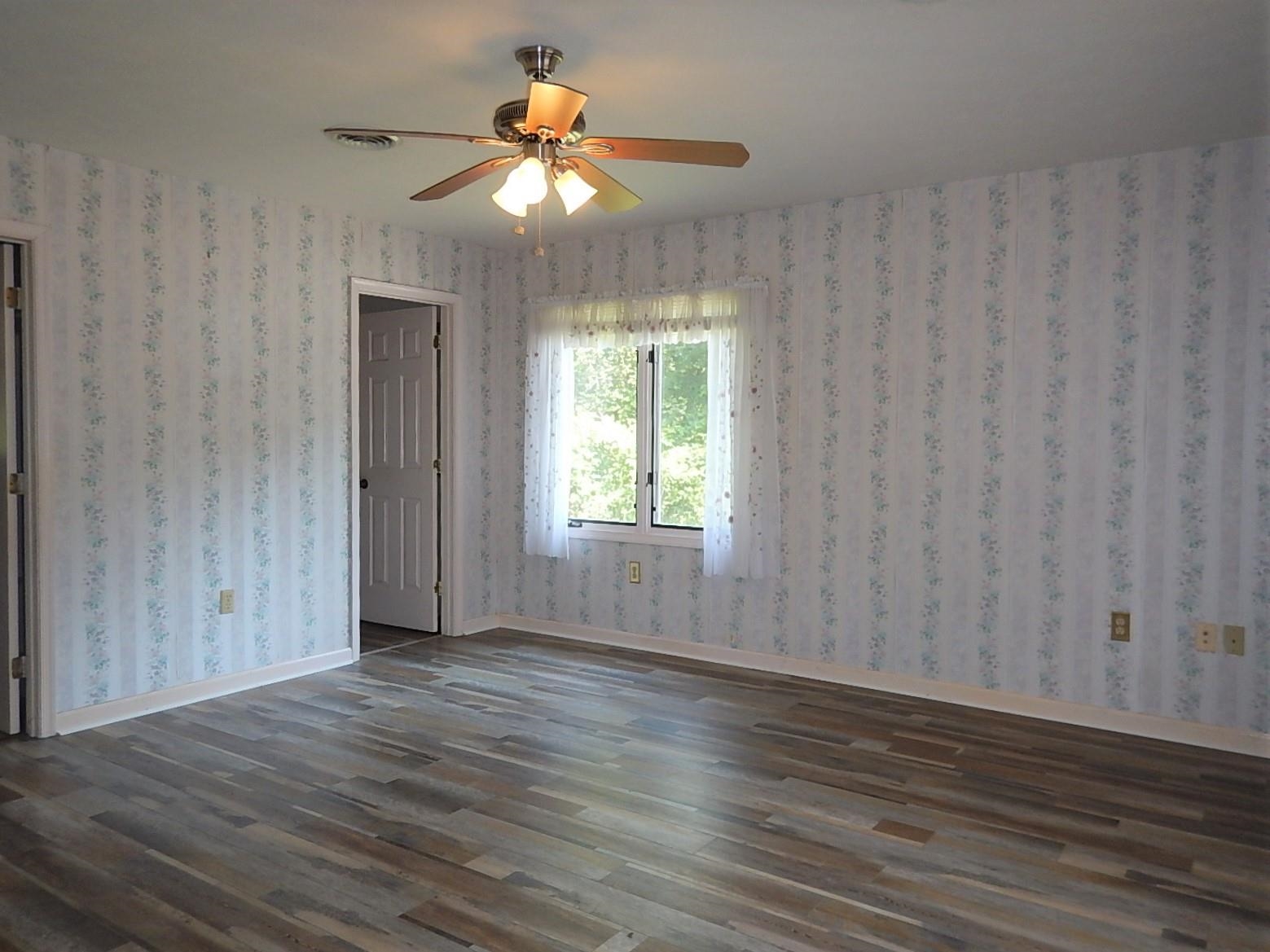 161 Smoky Row Road Staunton, VA 24401 - Photo 15 of 25 a view of an empty room with wooden floor and a window