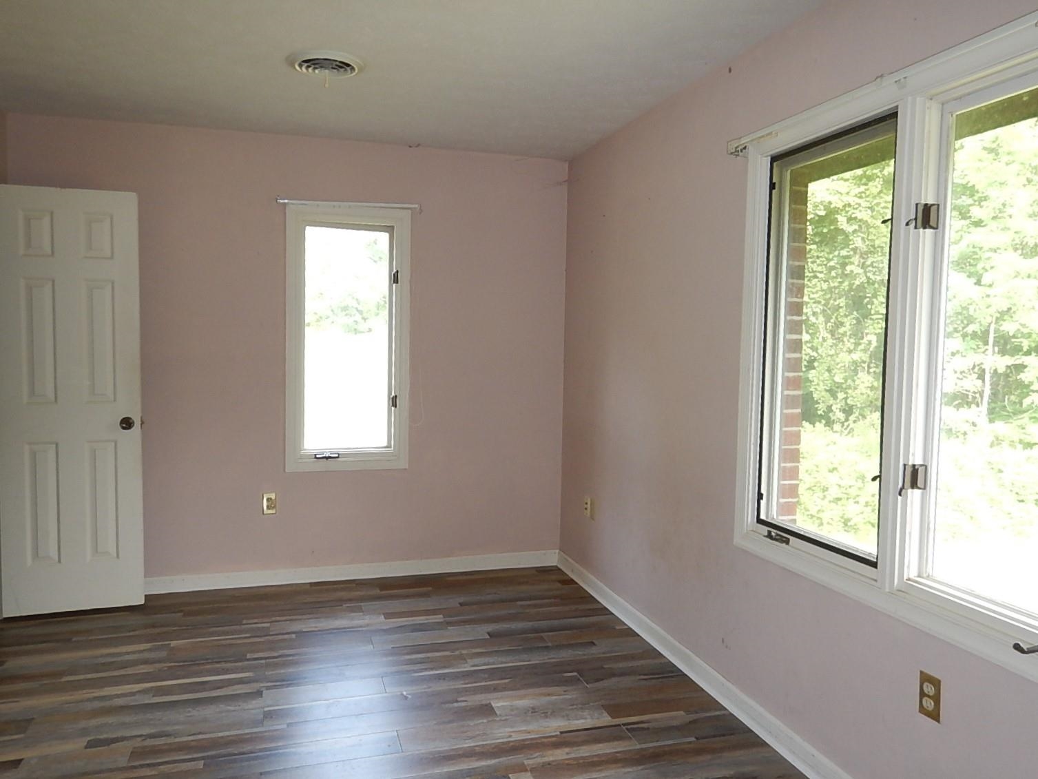 161 Smoky Row Road Staunton, VA 24401 - Photo 18 of 25 a view of an empty room with wooden floor and a window