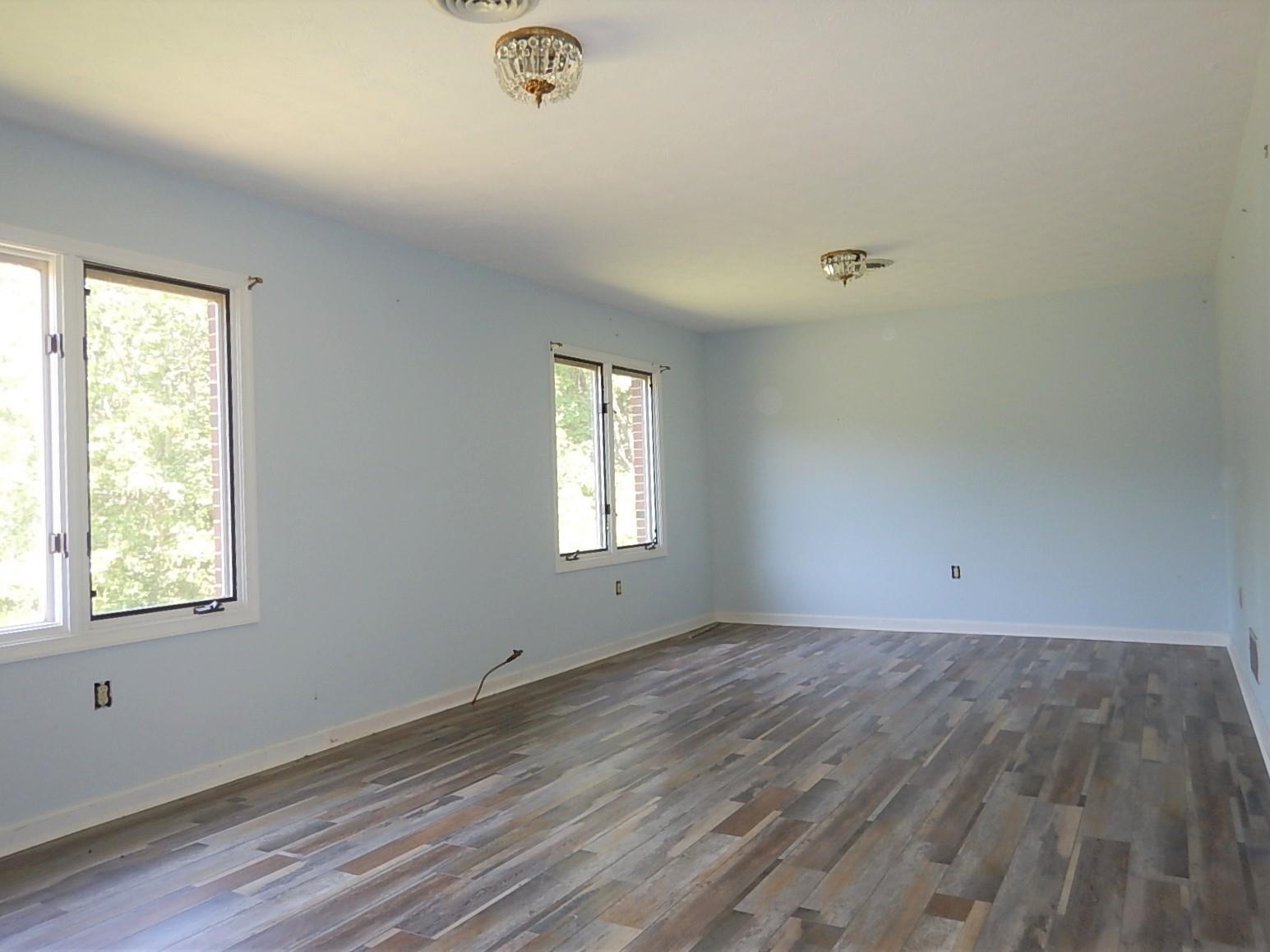 161 Smoky Row Road Staunton, VA 24401 - Photo 2 of 25 a view of an empty room with wooden floor and a window