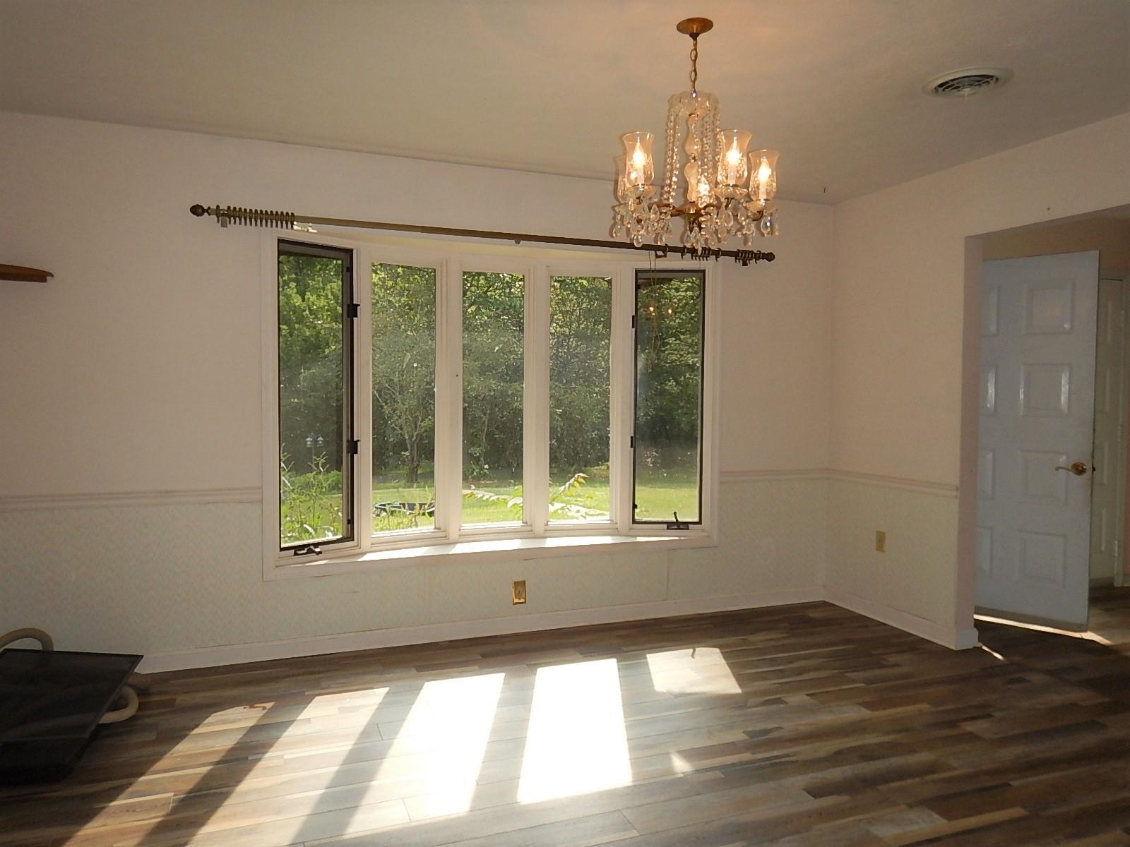161 Smoky Row Road Staunton, VA 24401 - Photo 4 of 25 a view of an empty room with wooden floor and a window
