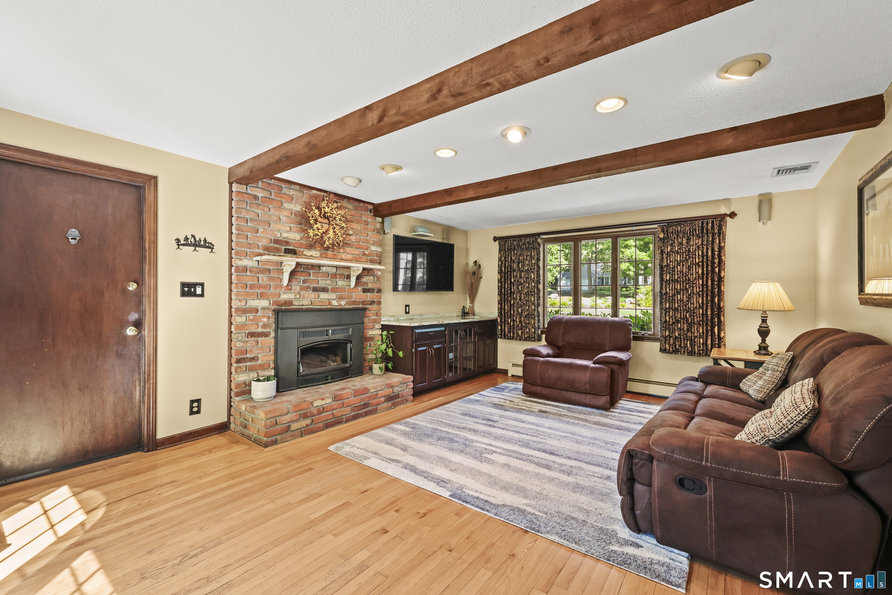 17 Briar Hill Road Avon, CT 06001 - Photo 28 of 39 This family room on the main floor features LOPI wood stove flush mount insert which has a blower. The door is the garage entrance. Perfect to warm the downstairs on a cool night.