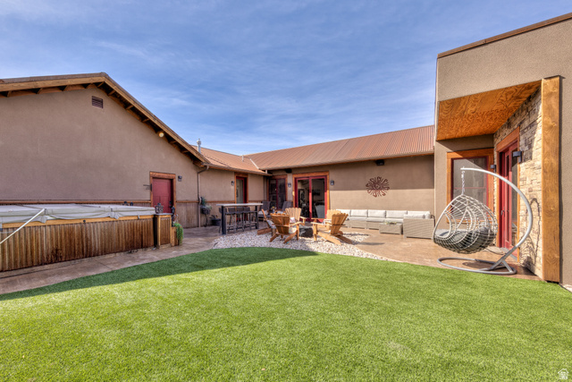 4173 Shadowfax Run, Unit 5 Moab, UT 84532 - Photo 37 of 41 Back Courtyard with outdoor living space, bar seating, a hot tub, and patio area around the fire pit