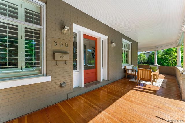 a balcony with furniture and a potted plant