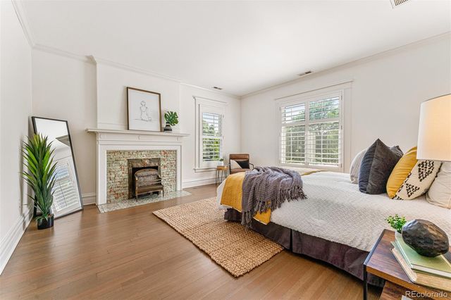 a bedroom with a bed and a fireplace