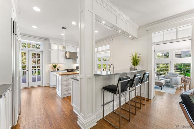 a kitchen with a table chairs refrigerator and cabinets