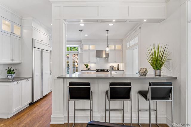 a kitchen with cabinets and chairs in it