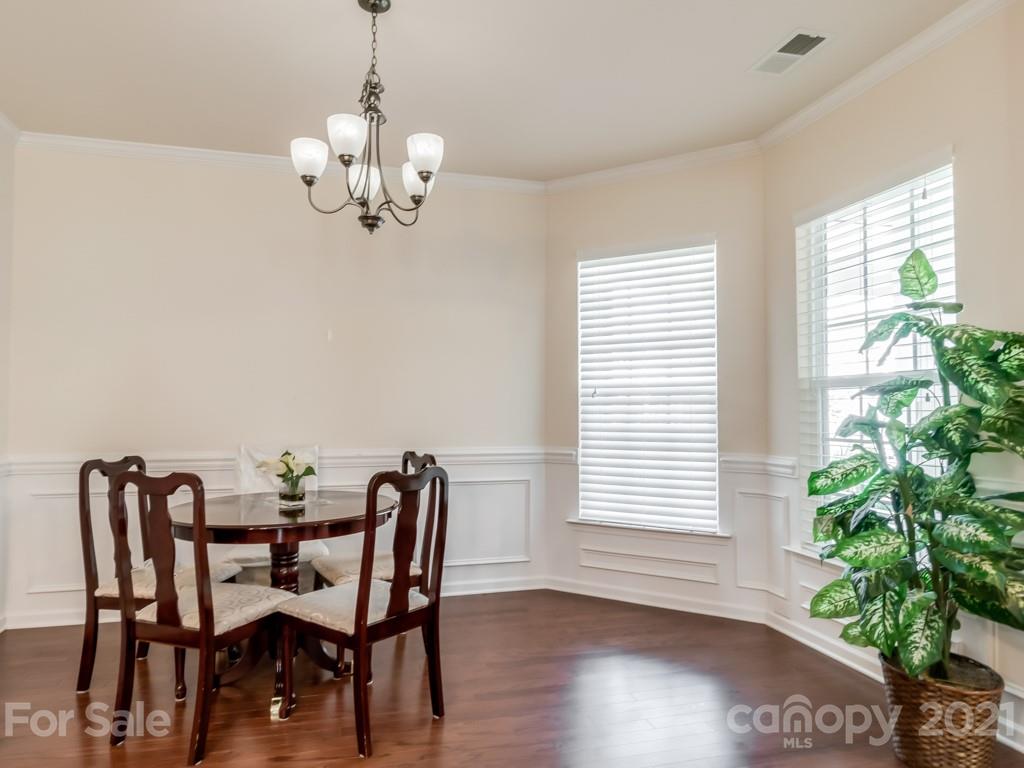 4142 Perth Road Indian Land, SC 29707 - Photo 12 of 26 a view of a dining room with furniture a chandelier and wooden floor