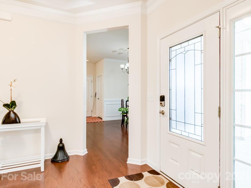 4142 Perth Road Indian Land, SC 29707 - Photo 7 of 26 a view of a hallway with wooden floor and a living room