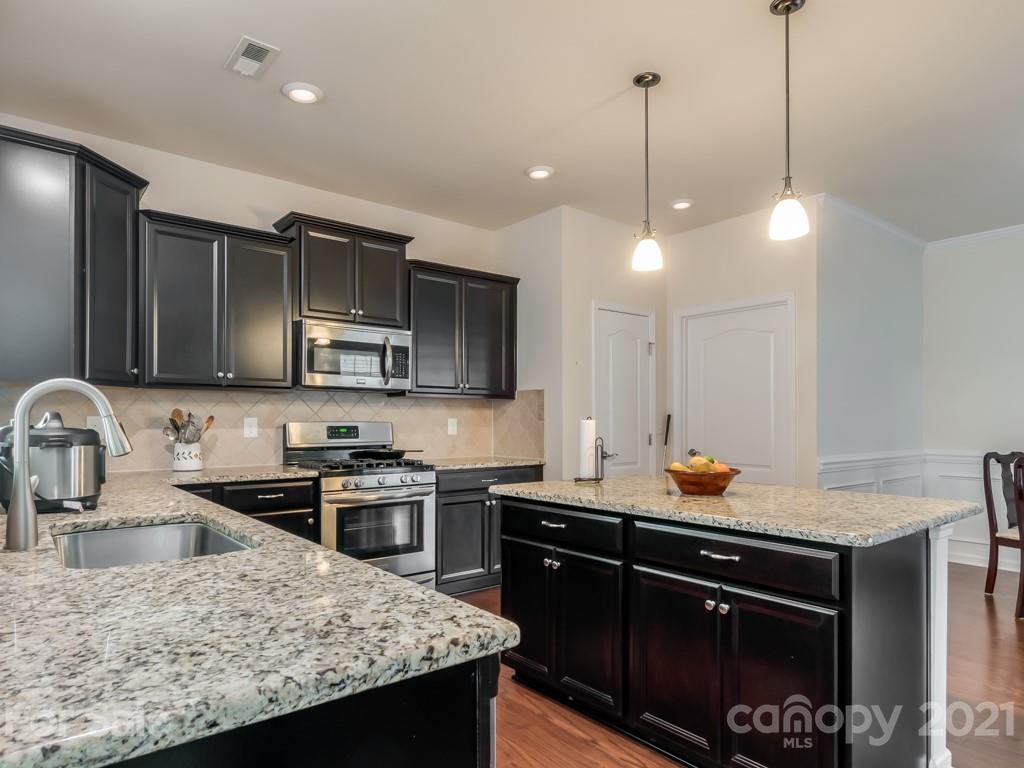4142 Perth Road Indian Land, SC 29707 - Photo 9 of 26 a kitchen with a sink a stove and cabinets